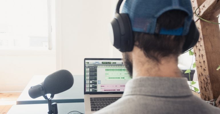 The Ultimate Guide to ELearning Voice Overs - Man records voice over on laptop
