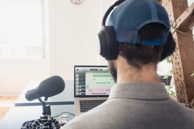 man records voice over on laptop