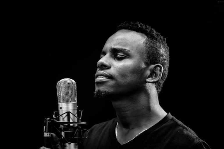 choose a voice over for your brand - male voice talent with microphone