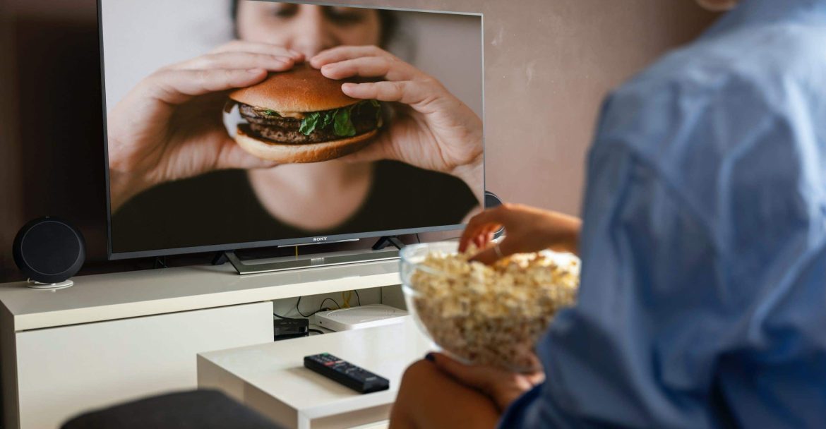 How Long Should TV Commercial Be - Man watches burger ad