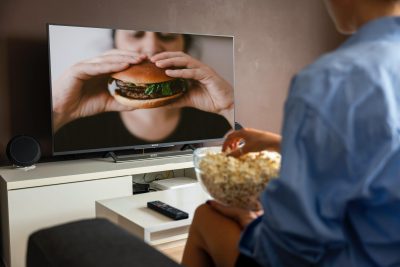 How Long Should TV Commercial Be - Man watches burger ad