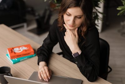 How to Write Killer Commercial Scripts - woman types on her laptop