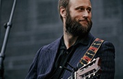 Bearded man with an acoustic guitar