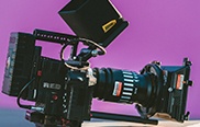 A Video Camera against a purple background