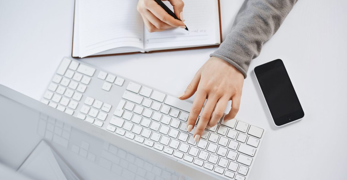 How to Quickly Transcribe a YouTube Video to Text — Woman Transcribing in a Notebook